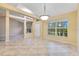 Open living area with tile floors, lots of light from a window, and a spacious design with a front door view at 14256 Salvatierra Ln, Port Charlotte, FL 33981