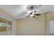 Bright living room featuring a ceiling fan and natural light from the window at 14256 Salvatierra Ln, Port Charlotte, FL 33981