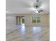 Bright and airy living room featuring neutral tile, sliding glass doors and a view of the backyard at 14256 Salvatierra Ln, Port Charlotte, FL 33981