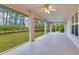 Relaxing screened patio with ceiling fan overlooking backyard and lush greenery at 14256 Salvatierra Ln, Port Charlotte, FL 33981
