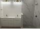 Modern bathroom featuring a double vanity and a shower with marble-like tile at 14914 San Domingo Blvd, Port Charlotte, FL 33981