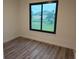 Bedroom with wood flooring and large window at 14914 San Domingo Blvd, Port Charlotte, FL 33981