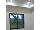 Bedroom features a large window offering natural light, ceiling fan, and tray ceilings at 14914 San Domingo Blvd, Port Charlotte, FL 33981