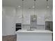 Modern kitchen features stainless appliances, a marble backsplash, an island and modern pendant lighting at 14914 San Domingo Blvd, Port Charlotte, FL 33981