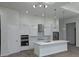 Modern kitchen features stainless appliances, a marble backsplash, an island and modern pendant lighting at 14914 San Domingo Blvd, Port Charlotte, FL 33981