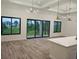 Open floor plan features a kitchen flowing into the living room, large windows, and sliding glass doors at 14914 San Domingo Blvd, Port Charlotte, FL 33981