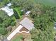 Aerial view of a charming home, showing its roof and driveway amidst lush greenery and mature trees at 14050 Blackjack Rd, Dover, FL 33527