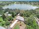 Aerial view featuring a home near a lake, surrounded by mature trees, showcasing its serene and private setting at 14050 Blackjack Rd, Dover, FL 33527