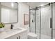 Modern bathroom featuring a glass enclosed shower, white vanity, and updated fixtures at 14050 Blackjack Rd, Dover, FL 33527