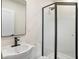 Modern bathroom features a corner shower, black fixtures, and a white vanity at 14050 Blackjack Rd, Dover, FL 33527