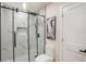 Modern bathroom with a glass-enclosed shower, white marble-style tile, and black hardware at 14050 Blackjack Rd, Dover, FL 33527