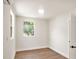 Sunlit bedroom with wood floors, white trim, and a large window providing nice view at 14050 Blackjack Rd, Dover, FL 33527