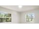 This bright, vacant bedroom has two windows providing natural light and views at 14050 Blackjack Rd, Dover, FL 33527