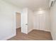 This bright bedroom has wood-look flooring, a closet, and access to another room at 14050 Blackjack Rd, Dover, FL 33527