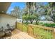 Inviting wooden deck with seating overlooks the serene backyard and waterfront at 14050 Blackjack Rd, Dover, FL 33527