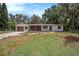 Charming single-story home with neutral paint, a two-car garage, well-manicured lawn, and inviting curb appeal at 14050 Blackjack Rd, Dover, FL 33527