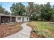 Well-maintained home with a new walkway, fresh mulch, and decorative chairs that create an inviting curb appeal at 14050 Blackjack Rd, Dover, FL 33527