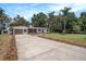 Well-maintained single-story home featuring a long driveway and inviting curb appeal with tasteful landscaping at 14050 Blackjack Rd, Dover, FL 33527