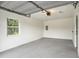 Spacious, clean garage featuring ample room for parking and storage, a new coat of paint, and a bright window at 14050 Blackjack Rd, Dover, FL 33527