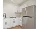 Bright kitchen features white cabinets, quartz countertops, and stainless steel refrigerator at 14050 Blackjack Rd, Dover, FL 33527