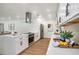 Modern kitchen featuring white cabinets, stainless steel appliances, and a stylish range hood at 14050 Blackjack Rd, Dover, FL 33527