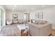 Living room with grey sofas, sleek coffee table, and view into the open concept kitchen space at 14050 Blackjack Rd, Dover, FL 33527