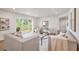 Spacious living room featuring neutral tones, wood floors, and sliding doors opening to the backyard at 14050 Blackjack Rd, Dover, FL 33527