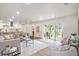 Open concept living room with modern furnishings, a view of the kitchen and a sliding glass door to the deck at 14050 Blackjack Rd, Dover, FL 33527