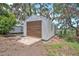 Metal outbuilding with a roll-up door and concrete pad, perfect for storage or a workshop at 14050 Blackjack Rd, Dover, FL 33527