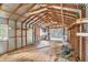 The interior of the metal outbuilding, with exposed beams, plywood floor and a window at 14050 Blackjack Rd, Dover, FL 33527