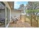A wooden deck with Adirondack chairs, a great space to enjoy the beautiful backyard at 14050 Blackjack Rd, Dover, FL 33527