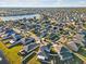 Aerial view of a meticulously planned neighborhood featuring a lake and single-Gathering homes with well-manicured lawns at 8506 Hunters Fork Loop, Ruskin, FL 33573