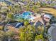 Aerial view of a resort-style pool area, clubhouse, playground, and well-maintained landscaping in a vibrant community at 8506 Hunters Fork Loop, Ruskin, FL 33573