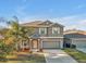 Charming two-story home boasts a well-maintained lawn and a two-car garage at 8506 Hunters Fork Loop, Ruskin, FL 33573
