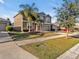 Charming two-story home with green lawn and sidewalk at 8506 Hunters Fork Loop, Ruskin, FL 33573