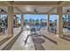 Covered patio area with seating overlooking the community pool at 8506 Hunters Fork Loop, Ruskin, FL 33573
