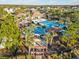 Large community pool area featuring cabanas, lounge chairs, and lush landscaping at 8506 Hunters Fork Loop, Ruskin, FL 33573