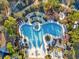 Aerial view of a resort style community pool surrounded by lounging chairs and landscaped grounds at 8506 Hunters Fork Loop, Ruskin, FL 33573