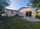Exterior of home showing backyard with patio and sliding glass door at 3217 Deerfield Dr, Tampa, FL 33619
