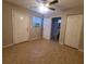 Bright bedroom with a ceiling fan, tan tiled floor, and a closet at 3217 Deerfield Dr, Tampa, FL 33619