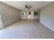 A versatile bonus room with durable tile flooring, natural light, and neutral paint color at 3217 Deerfield Dr, Tampa, FL 33619