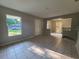 A cozy living room area featuring tile flooring and natural light from a large window at 3217 Deerfield Dr, Tampa, FL 33619