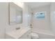 Spotless bathroom with a modern vanity, tiled walls, and a shower-tub combination at 19543 Midway Blvd, Port Charlotte, FL 33948