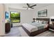 Comfortable bedroom featuring a large window, neutral decor, and ample natural light at 19543 Midway Blvd, Port Charlotte, FL 33948