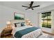 Serene bedroom featuring a plush bed, stylish decor, and a bright window with natural light at 19543 Midway Blvd, Port Charlotte, FL 33948