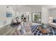 Open-concept living area with modern furniture, wood-look floors, and access to the kitchen at 19543 Midway Blvd, Port Charlotte, FL 33948
