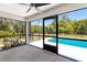 Enclosed patio area featuring views of the pool and yard at 19543 Midway Blvd, Port Charlotte, FL 33948