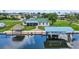 Waterfront home with lush landscaping, private dock, tiki hut and boat lift at 24277 Treasure Island Blvd, Punta Gorda, FL 33955