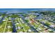 Aerial view of a coastal community with waterfront homes and canal access to open water at 24277 Treasure Island Blvd, Punta Gorda, FL 33955