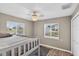 Bright bedroom with wood floors, ceiling fan, and windows providing plenty of natural light at 24277 Treasure Island Blvd, Punta Gorda, FL 33955